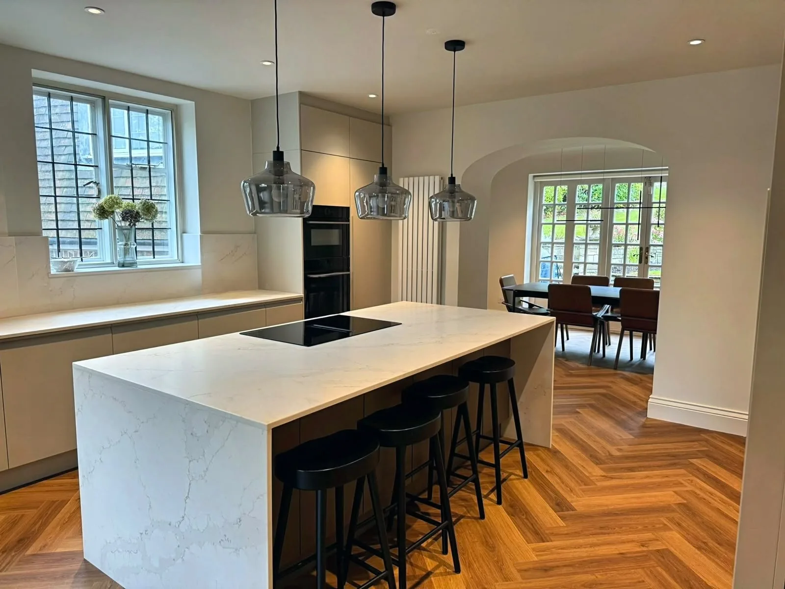 Modern kitchen with marble island and pendant lights