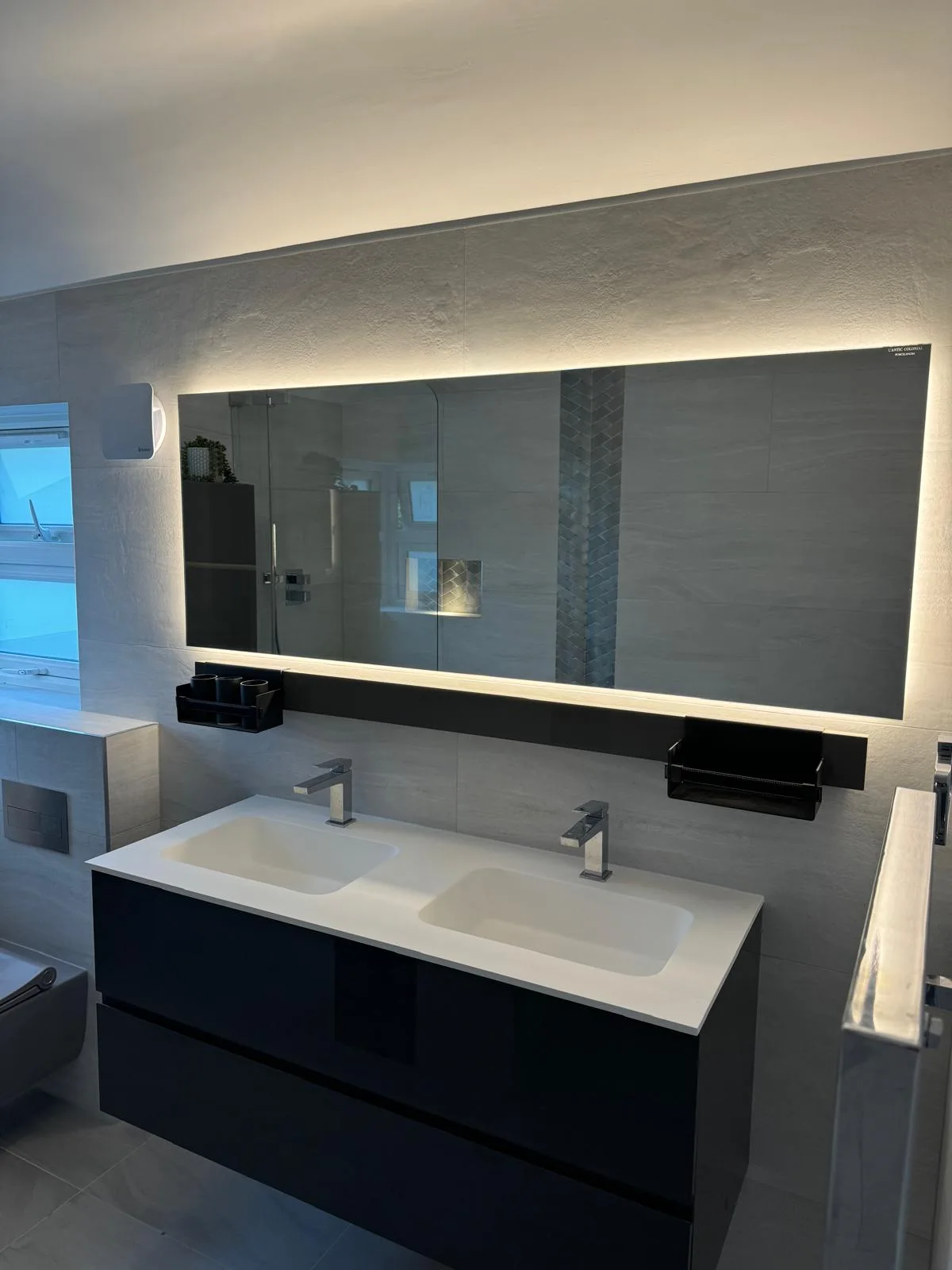 Modern bathroom with a double vanity, wall-mounted mirror, and stylish fixtures