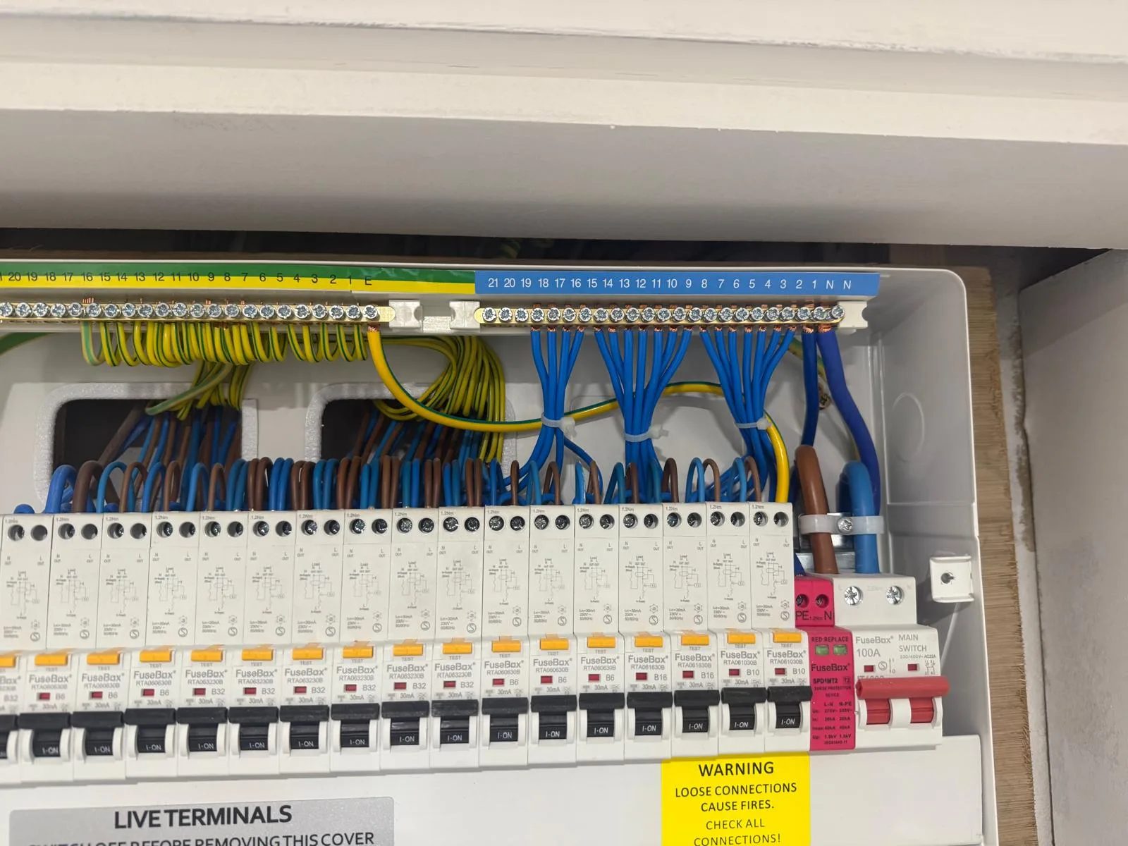 Electrical panel with wires and circuit breakers visibly organized