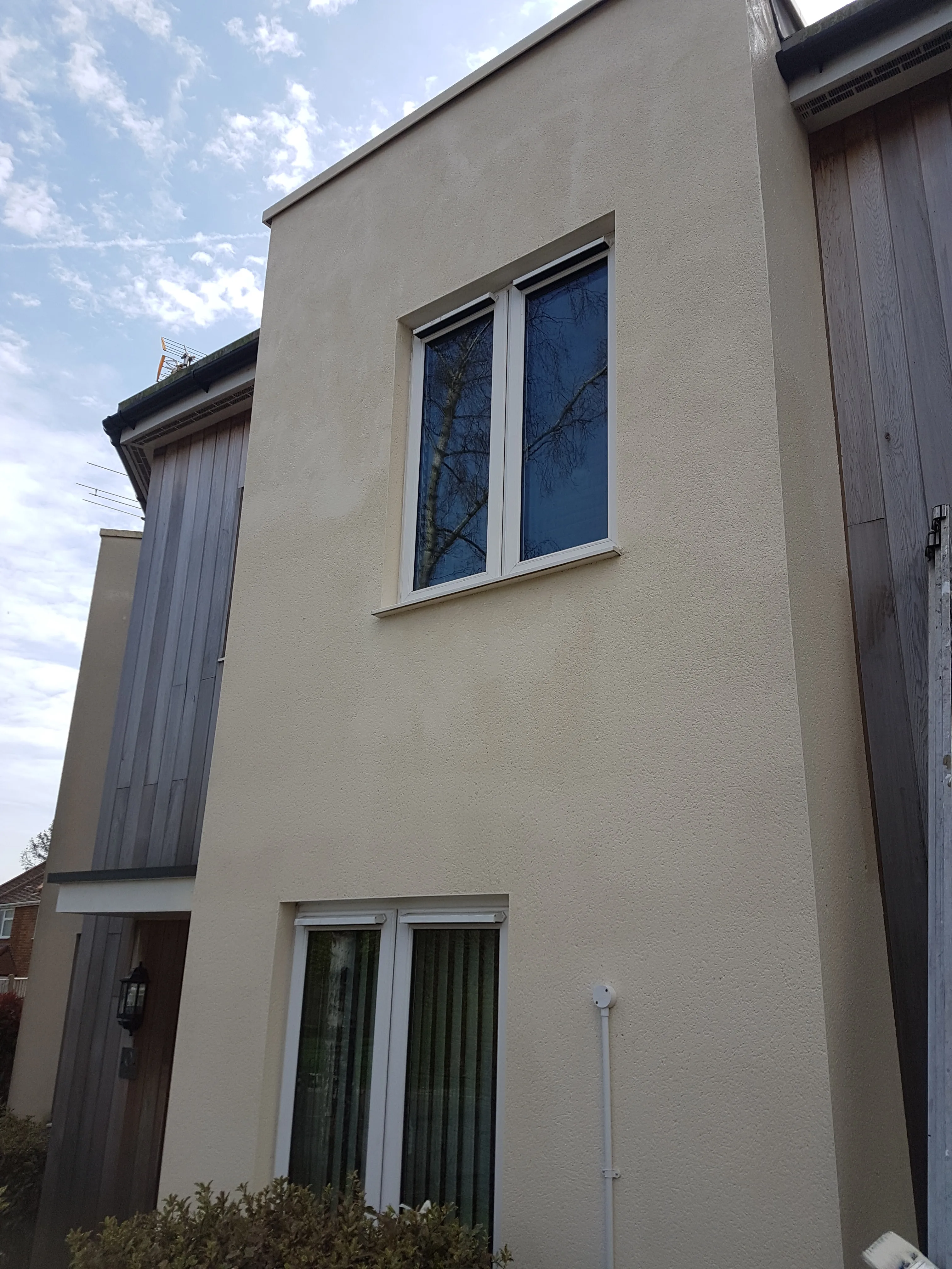 Recently renovated external wall with new render and modern windows