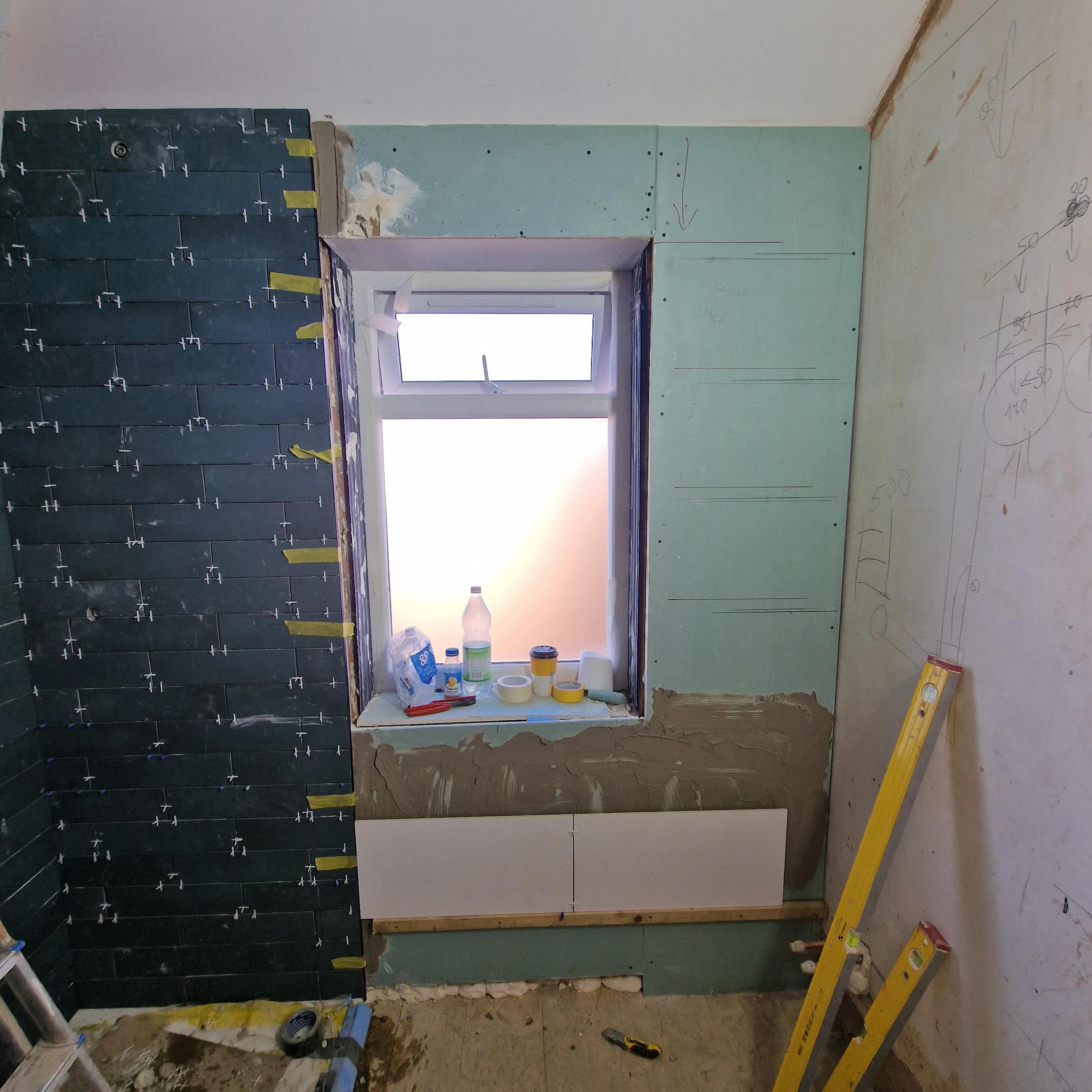 Renovation work in progress, showcasing a window frame and wall preparations
