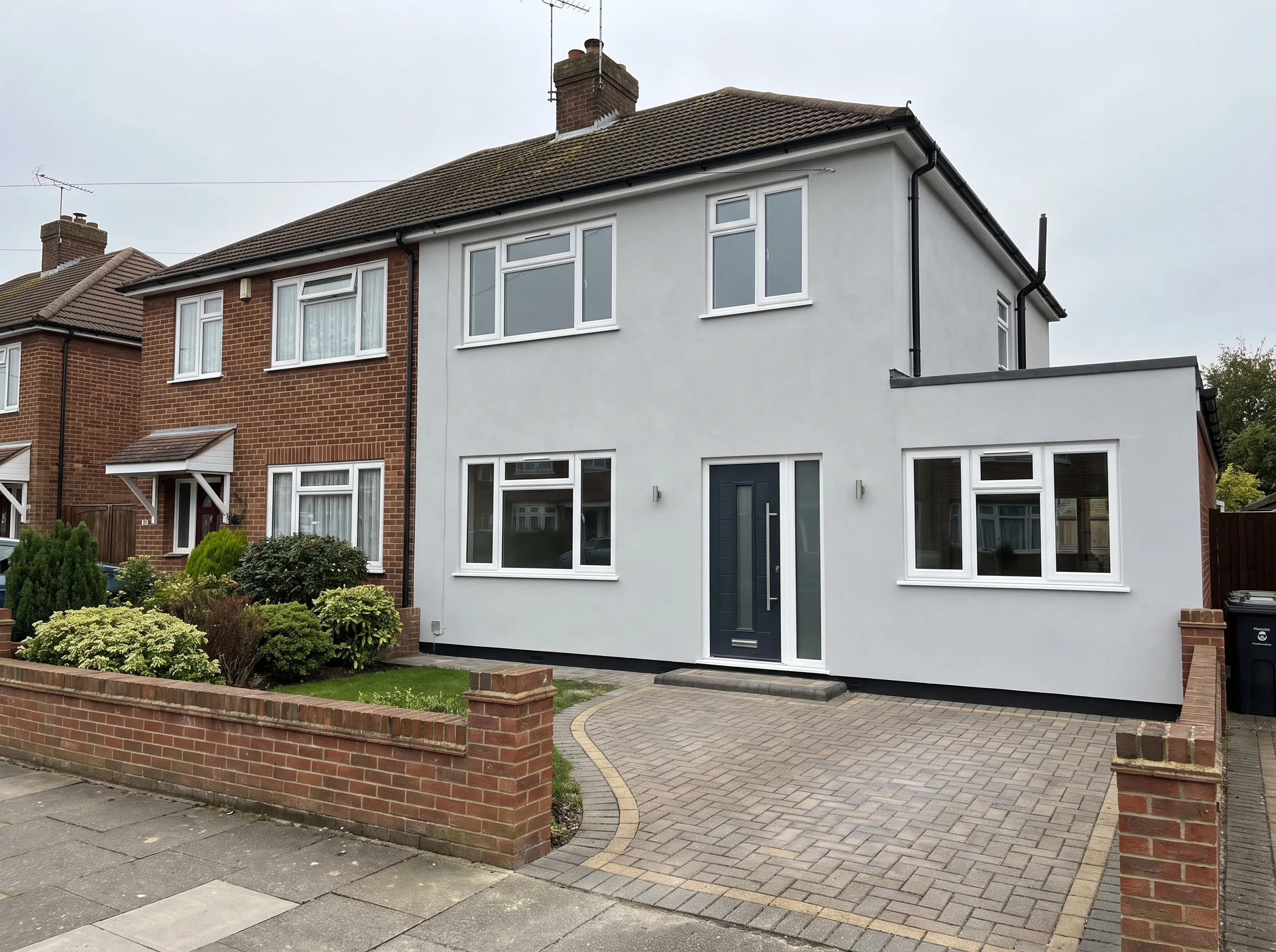 Freshly renovated home exterior with modern façade and landscaped front garden