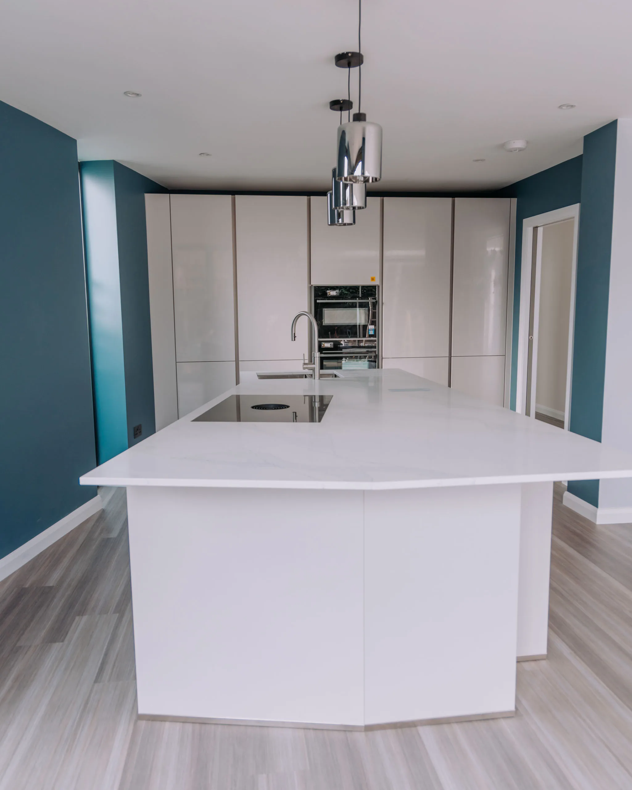 Modern kitchen refurbishment featuring a sleek island with sink