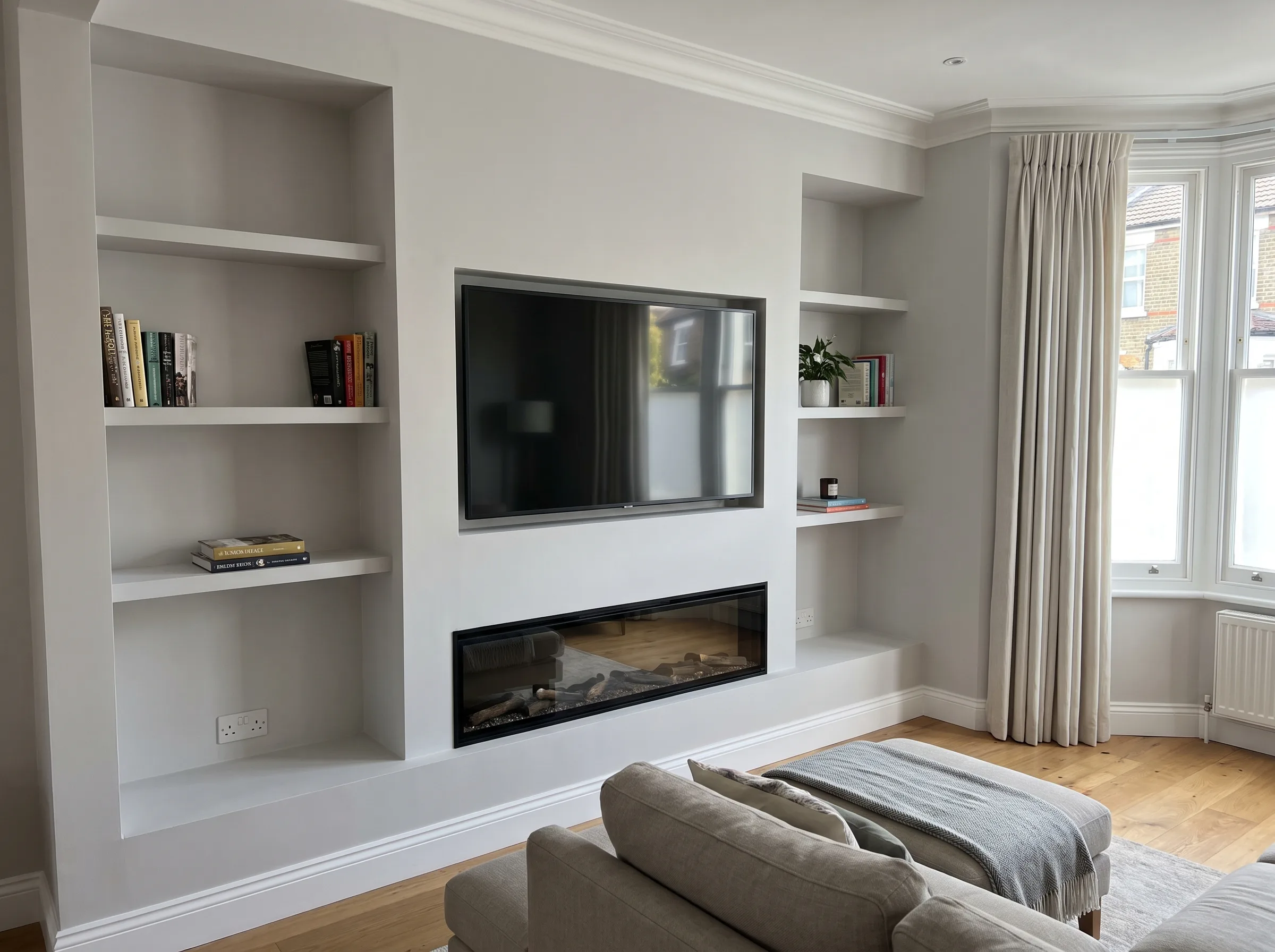 Modern living room with a media wall, showcasing a TV and shelving