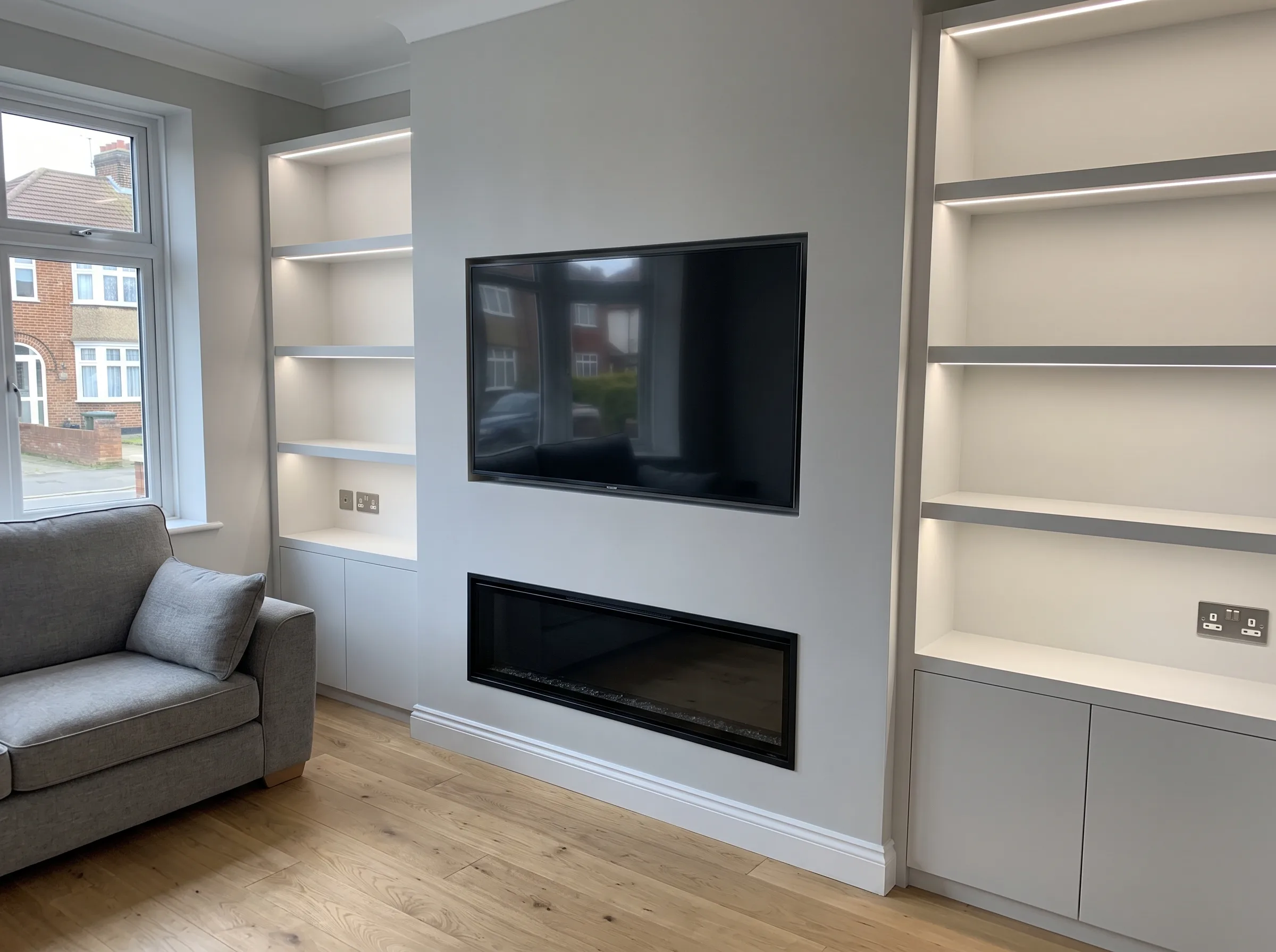 Modern living room with a sleek media wall and built-in shelves